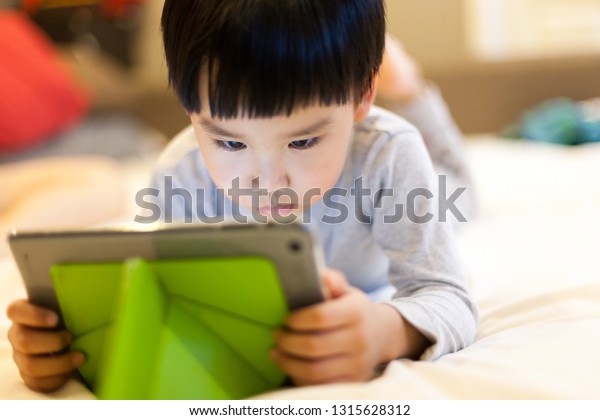 Asian Boys Playing Tablat On Bed Stock Photo Edit Now 1315628312