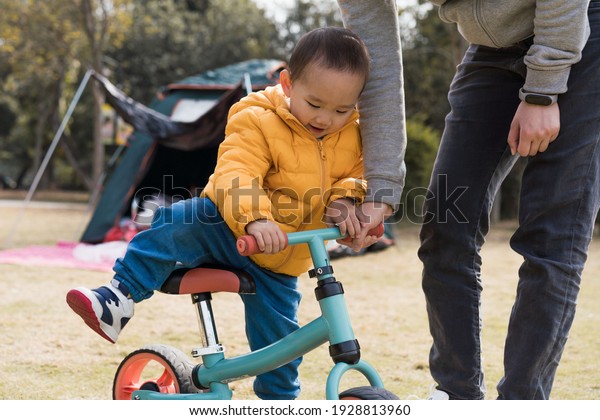 Asian Boys\
practice riding a balance car\
outdoors