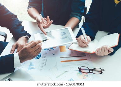 Asian business adviser meeting to analyze and discuss the situation on the financial report in the meeting room.Investment Consultant,Financial Consultant,Financial advisor and accounting concept - Shutterstock ID 1020878011