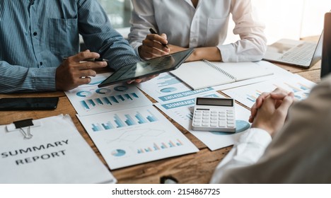 Asian Business Adviser Meeting To Analyze And Discuss The Situation On The Financial Report In The Meeting Room.Investment Consultant, Financial Advisor And Accounting Concept