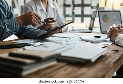 Asian business adviser meeting to analyze   discuss the situation the financial report in the meeting room Investment Consultant  Financial advisor   accounting concept