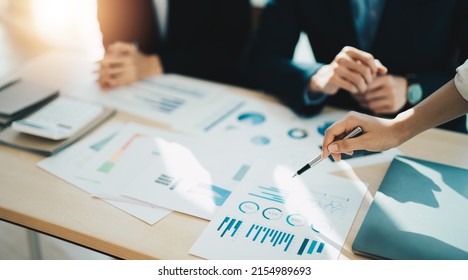 Asian business adviser meeting to analyze and discuss the situation on the financial report in the meeting room.Investment Consultant, Financial advisor and accounting concept. - Shutterstock ID 2154989693