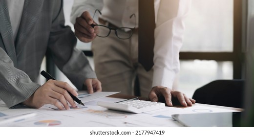 Asian business adviser meeting to analyze and discuss the situation on the financial report in the meeting room.Investment Consultant,Financial Consultant,Financial advisor and accounting concept - Shutterstock ID 2177947419