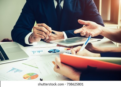 Asian business adviser meeting to analyze and discuss the situation on the financial report in the meeting room.Investment Consultant,Financial Consultant,Financial advisor and accounting concept