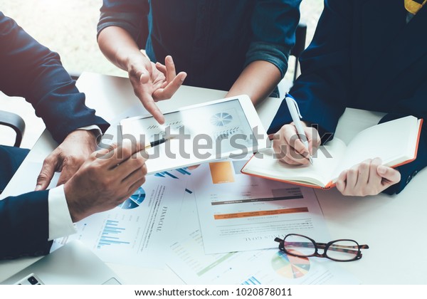 Asian business adviser meeting to analyze and\
discuss the situation on the financial report in the meeting\
room.Investment Consultant,Financial Consultant,Financial advisor\
and accounting concept\
