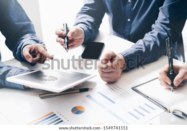 Asian business adviser meeting to analyze and\
discuss the situation on the financial report in the meeting\
room.Investment Consultant,Financial Consultant,Financial advisor\
and accounting\
concept\
\

