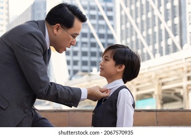 Asian Business Father And Son Confidence Child Want To Be Like A His Dad Parent And Young Boy Standing In City With Cityscape Background Planning In Future Life. Father Checking Clothes Son Business.