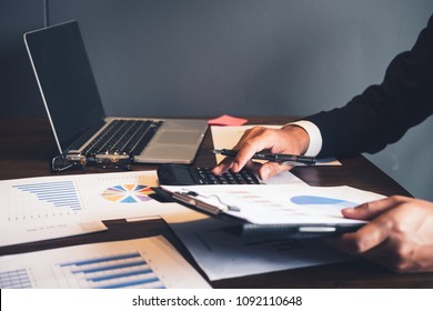 Asian business man analyze and discuss the situation on the marketing data online and calculate about cost in the meeting room. Business finances and accounting 