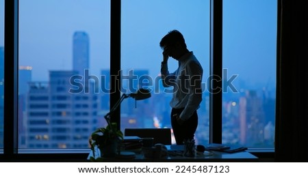 Asian business man being frustrated standing in office hopelessly