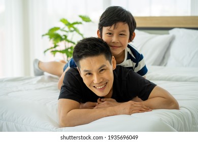 Asian business man father work from home and tacking care of son in new normal 