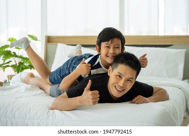 Asian Business Man Father Work From Home And Tacking Care Of Son In New Normal 