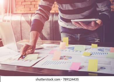 Asian business man hand holding note paper meeting with new startup project use post it notes to share idea discussion and analysis data charts and graphs.Business finances and accounting concept
 - Shutterstock ID 789124435