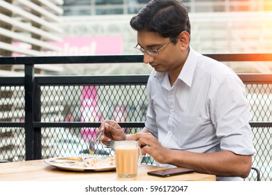 Asian Business Man Having Roti Canai Outdoor