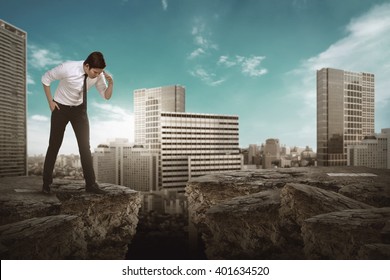 Asian Business Man Looking Down On Broken Road.