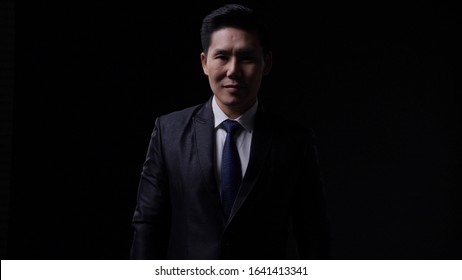 Asian Business Man Present Dress Appropriately For Formal Dress. Chinese Male Looking Modern Smart Watch. Concept Of Business People, Fashion Trend And Technology Digital.