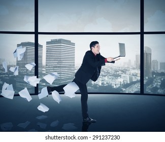 Asian Business Man Running With Laptop Inside Office Building