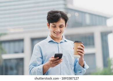 Asian business man standing in coffee and using cell phone

 - Powered by Shutterstock