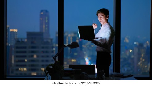 Asian business man standing in office using smartphone at night case accomplished  - Powered by Shutterstock