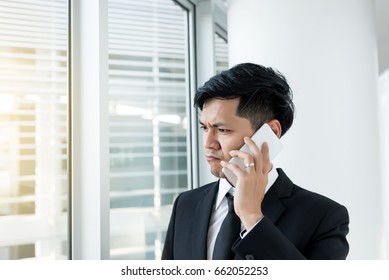 Asian Business Man Talk Talephone With Ceo Company About Work,he Stress Very Much