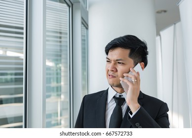 Asian Business Man Talk Talephone With Ceo Company About Work,he Stress Very Much