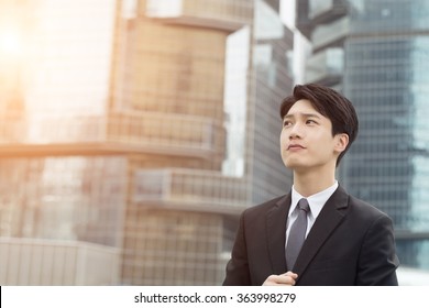 Asian Business Man Thinking At The City.