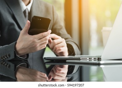 Asian Business Man Using Laptop And Smartphone