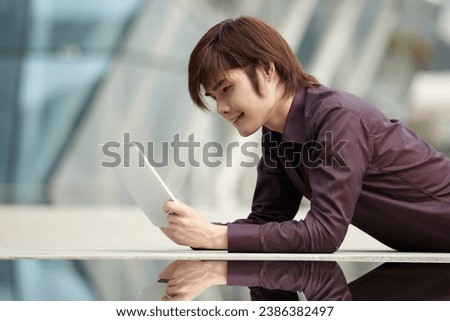 Asian Business man using a  touch pad PC