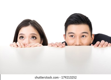 Asian Business Man And Woman Hide Under The Table And Looking Somewhere.