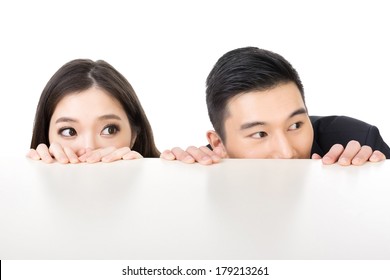 Asian Business Man And Woman Hide Under The Table And Looking Somewhere.