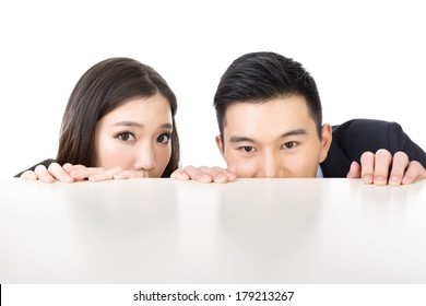 Asian Business Man And Woman Hide Under The Table And Looking Somewhere.