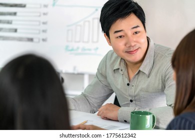 Asian Business Man Working And Discussing Together With Partner And Brainstorming Meeting At Workplace, Human Resource And Small Business Owner Concept