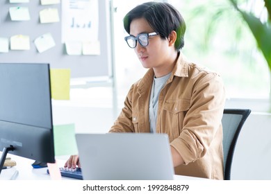 Asian business man working with laptop in office