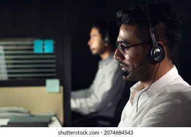 Asian Business Man Working Night Shift In Call Center Office With Colleague