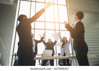 Asian Business People Celebrate With Paper Sheet In The Air In Office. Happy Moment Of Business Group.