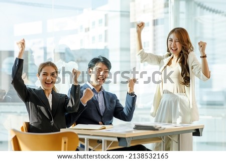 Asian Business people happy showing team work and giving five after signing agreement or contract with foreign partners in office interior. Happy people smiling. Agreement or contract concept.