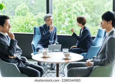 asian business people having a meeting in a hotel lounge - Powered by Shutterstock