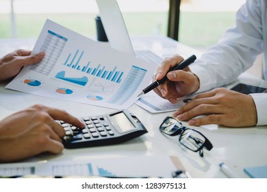Asian business people meeting new startup project pointing at graph discussion and analysis data charts and graphs.Business finances and accounting concept

 - Shutterstock ID 1283975131
