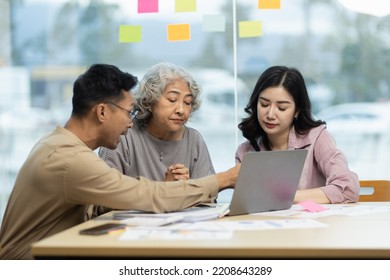 Asian business people meeting team  working with accounting documents and laptop at the table in office, Happy man working and business training to technology concept. - Shutterstock ID 2208643289