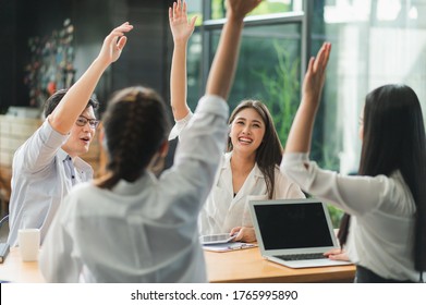 Asian Business People Raise Their Hands Together.