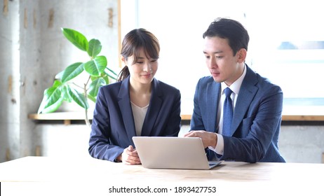 Asian Business People Staring At A Computer Screen