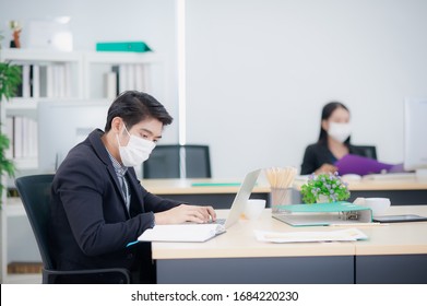 Asian Business People Working In The Office During The Coronavirus Or Covid -19 Spreading. Employees Must Wear A Medical Mask And Keep A Distance To Prevent Infection, New Normal Workplace Concept.