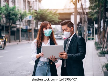 Asian Business People Working And Surveying Outdoor Location For New Business ,They 're Wearing Protective Mask To Provent Flu And Corona Virus (Covid-19) Outbreak - Healthcare And Business Concept