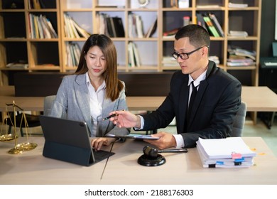 Asian Business Team And Lawyers Discussing Contract Papers Sitting At The Table. Concepts Of Law, Advice, Legal Services.  At Office