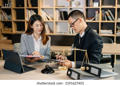 Asian Business Team And Lawyers Discussing Contract Papers Sitting At The Table. Concepts Of Law, Advice, Legal Services. At Modern Office	