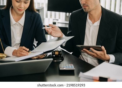 Asian Business Team And Lawyers Discussing Contract Papers Sitting At The Table. Concepts Of Law, Advice, Legal Services. At Modern Office