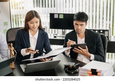 Asian Business Team And Lawyers Discussing Contract Papers Sitting At The Table. Concepts Of Law, Advice, Legal Services. At Modern Office