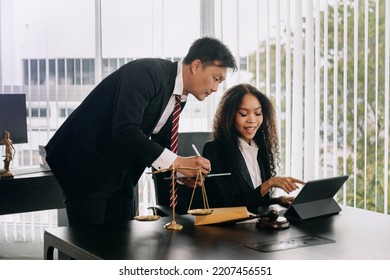 Asian Business Team And Lawyers Discussing Contract Papers Sitting At The Table. Concepts Of Law, Advice, Legal Services. At Modern Office