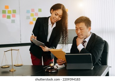 Asian Business Team And Lawyers Discussing Contract Papers Sitting At The Table. Concepts Of Law, Advice, Legal Services. At Modern Office