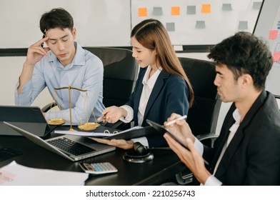 Asian Business Team And Lawyers Discussing Contract Papers Sitting At The Table. Concepts Of Law, Advice, Legal Services. At Modern Office