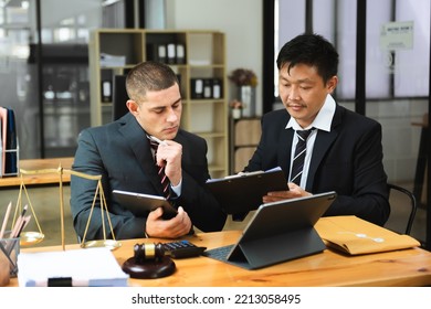 Asian Business Team And Lawyers Discussing Contract Papers Sitting At The Table. Concepts Of Law, Advice, Legal Services. 